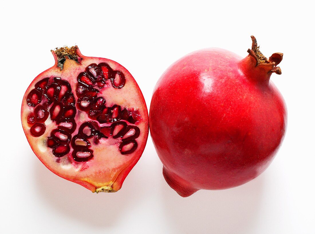 Whole and half pomegranate