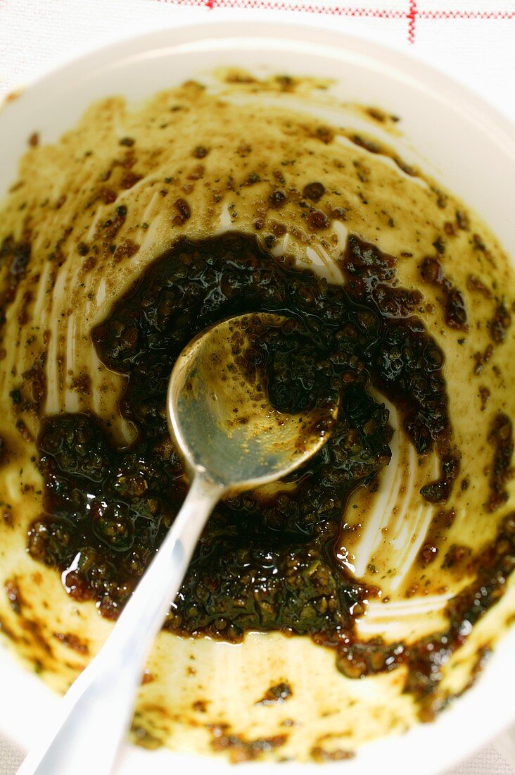 Pumpkin seed pesto in small bowl with spoon