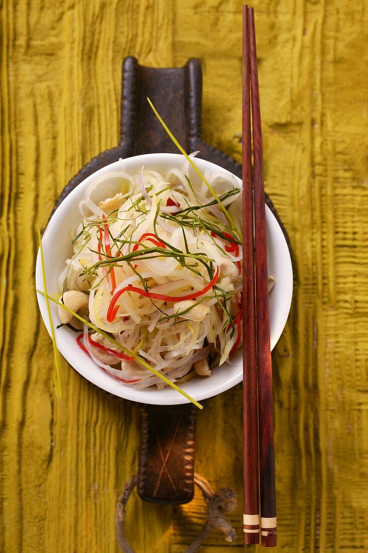 Salad of green papaya with strips of chili pepper