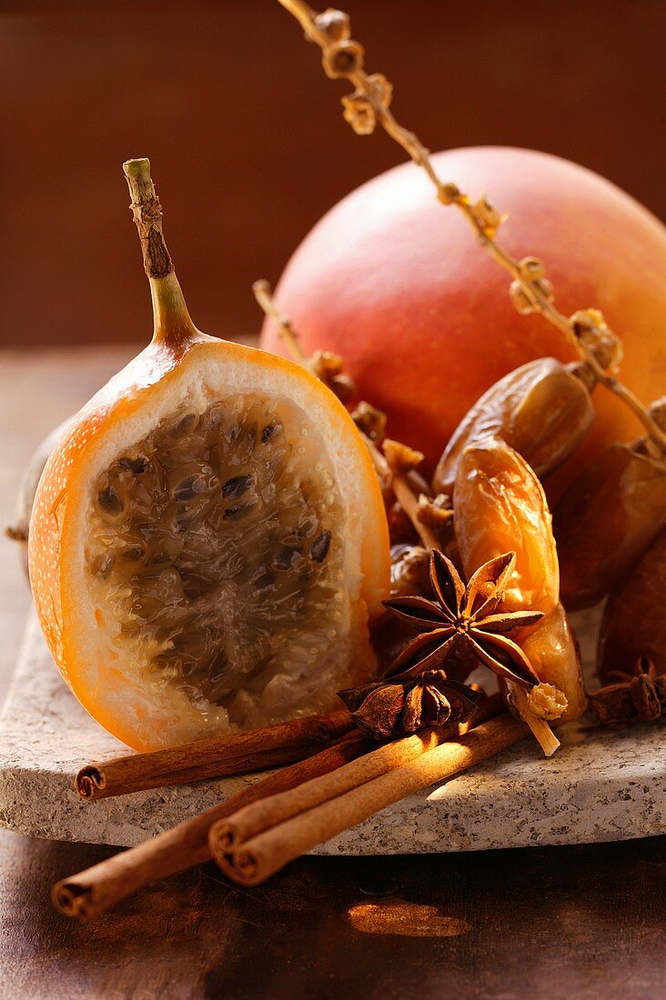 Stillleben mit Datteln, Sternanis, Zimt, Granadilla und Mango