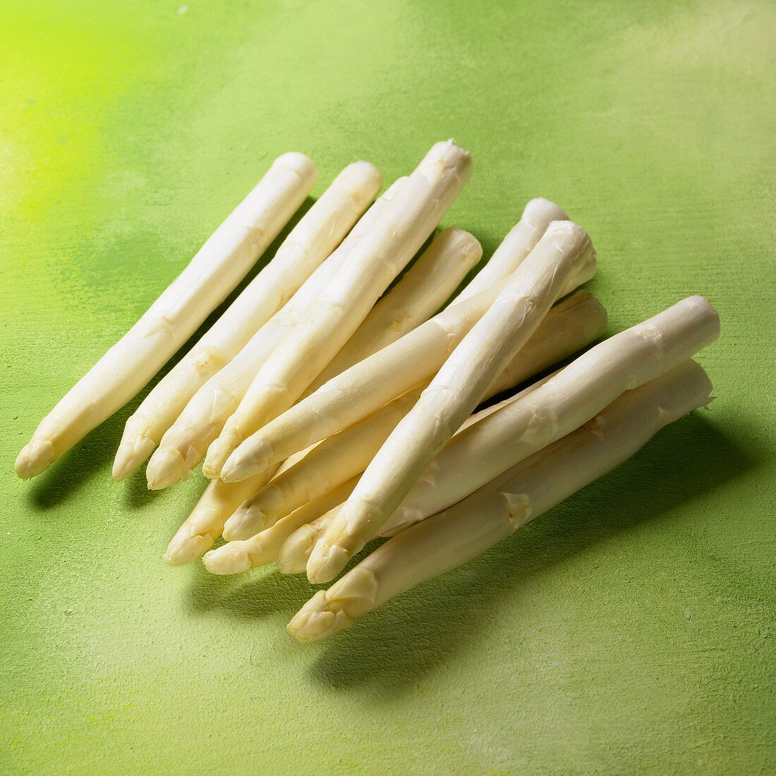 White asparagus on green background