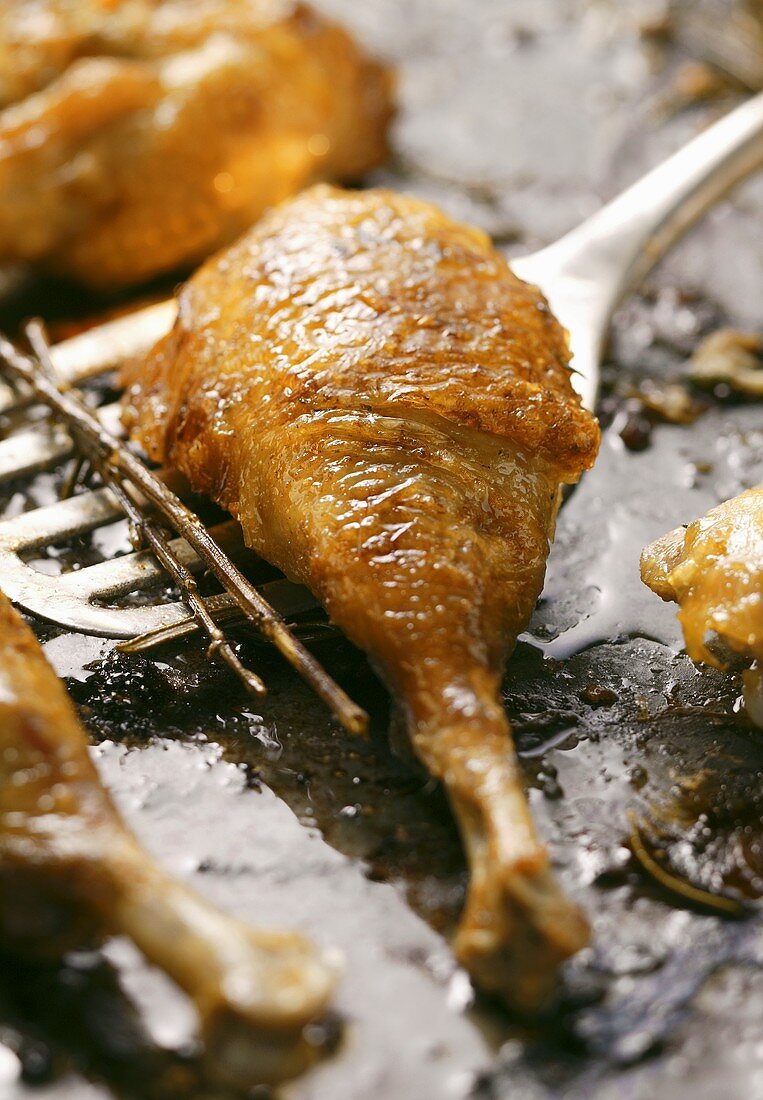 Crispy roast chicken legs on baking tray