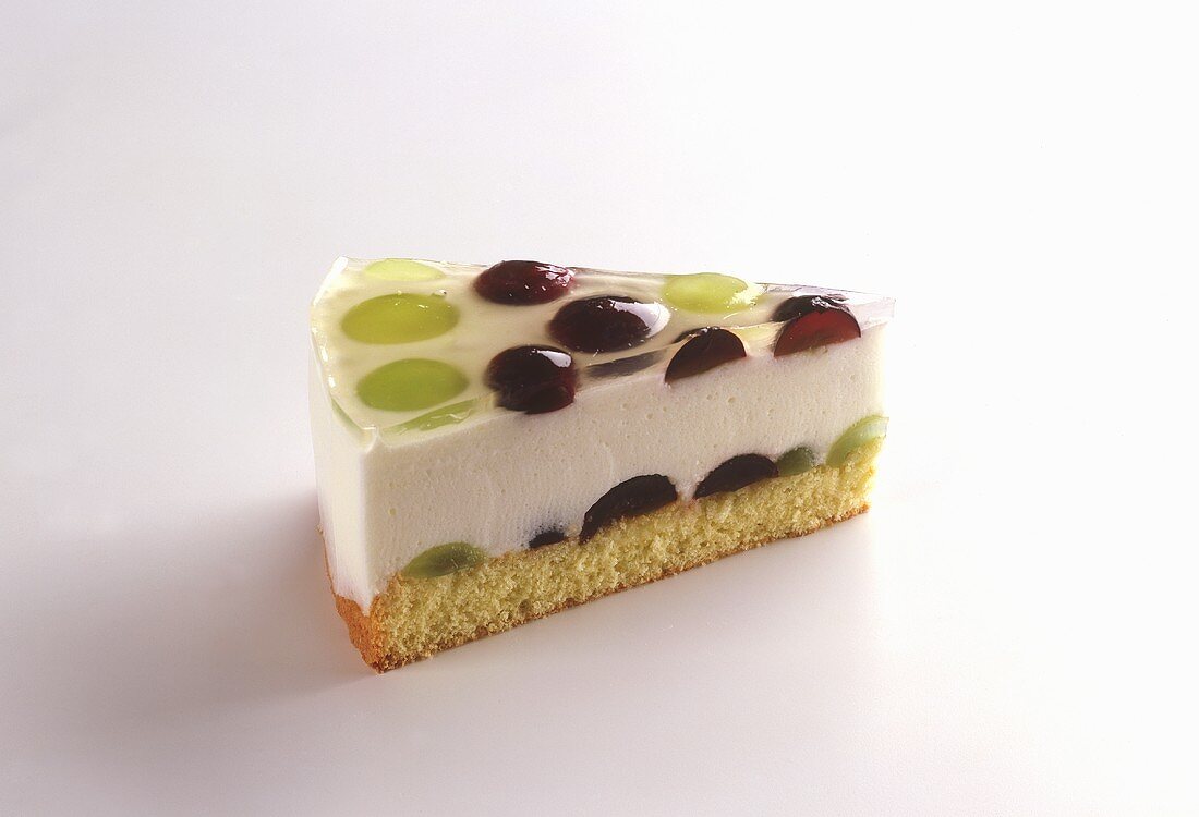 A piece of yoghurt cake with grapes