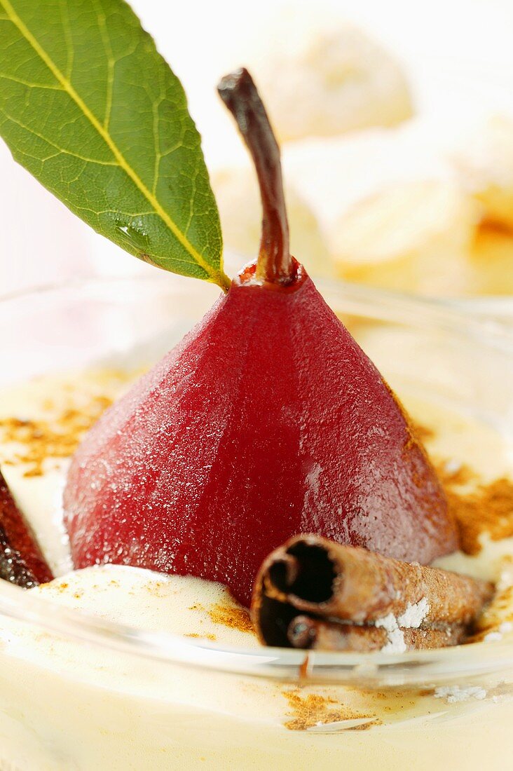 Pear in red wine with cinnamon in Madeira cream