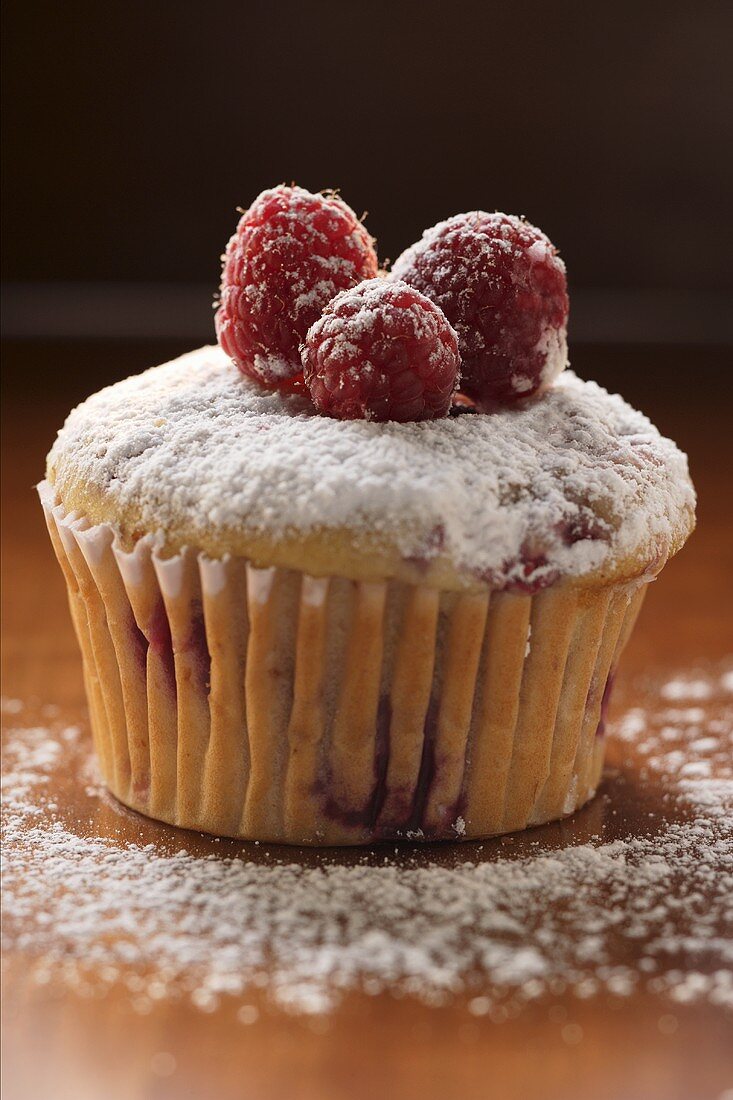 Raspberry muffin with icing sugar