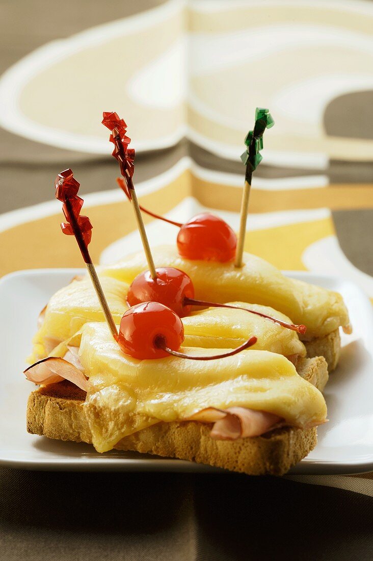 Ham and cheese on toast with cocktail cherries