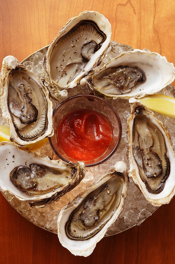 Oysters with cocktail sauce on ice
