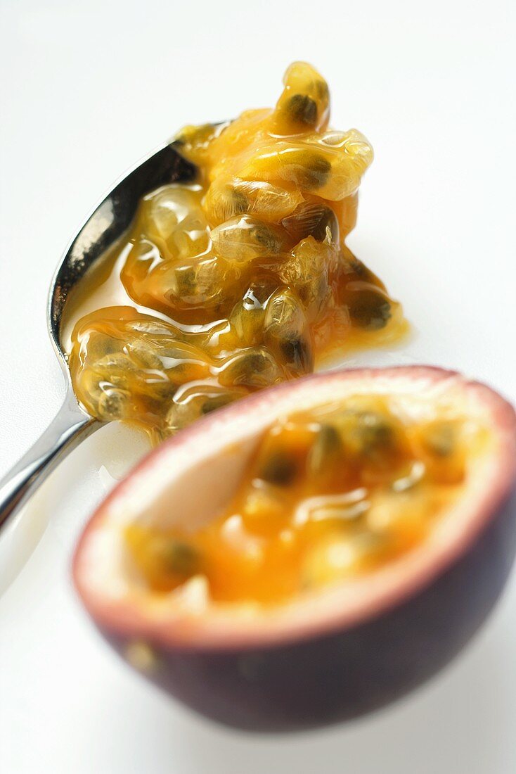 Spooning out passion fruit flesh (Purple granadilla)