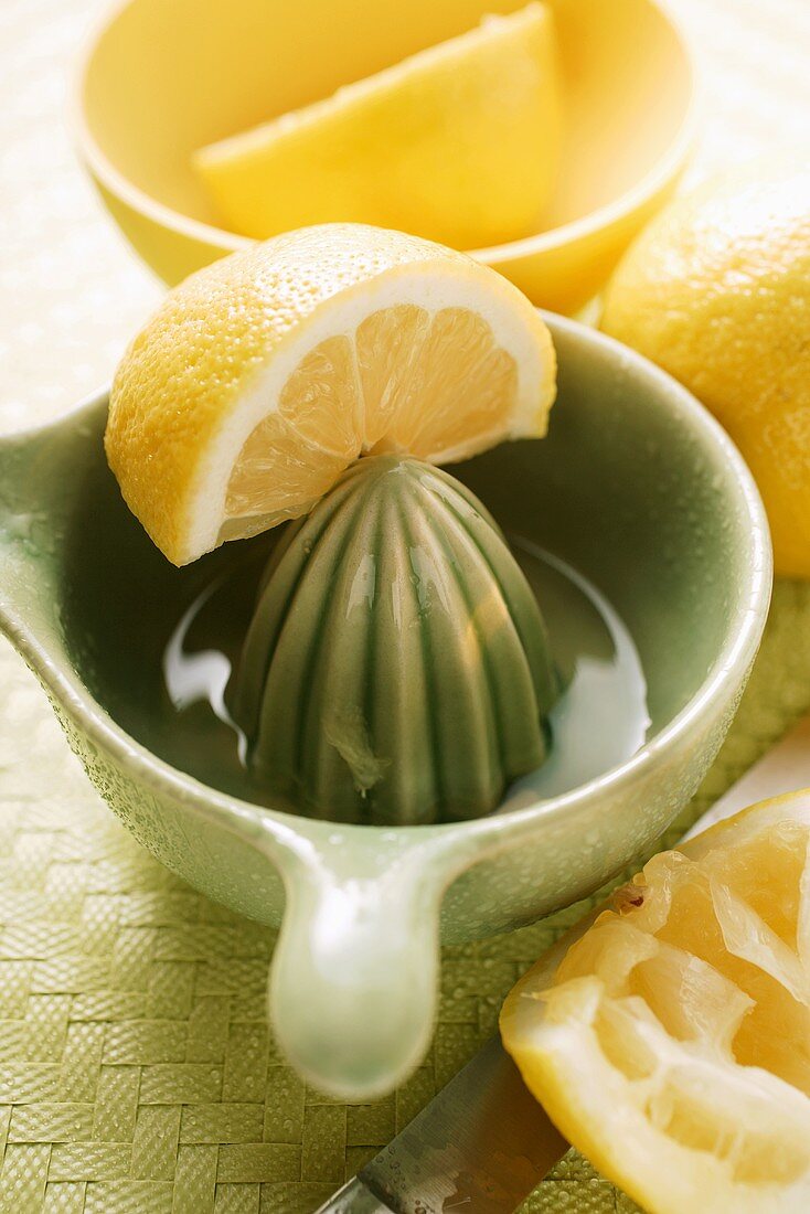 Lemons with lemon squeezer