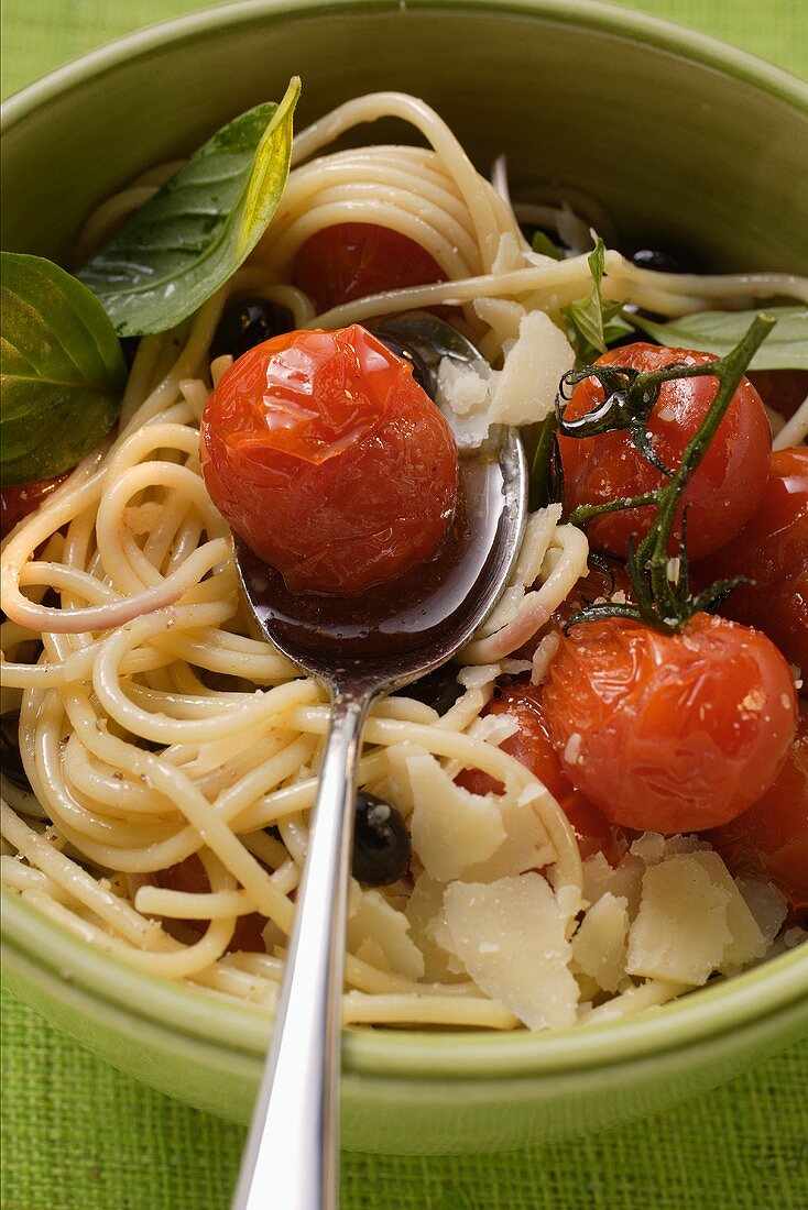 Spaghetti with cherry tomatoes, olives and Parmesan shavings