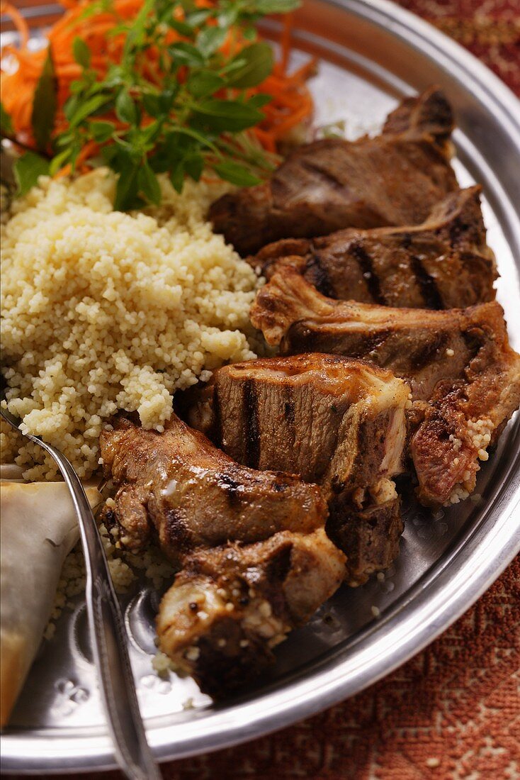 Grilled lamb cutlets with couscous and raw carrot salad