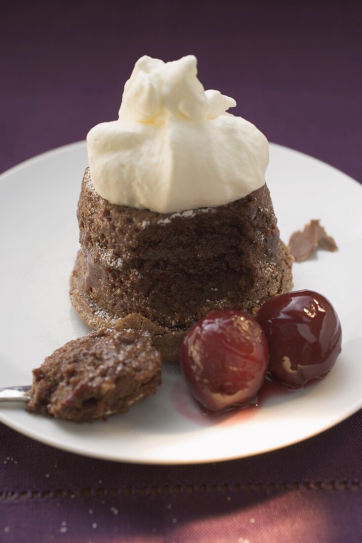 Chocolate soufflé with cream and cherries