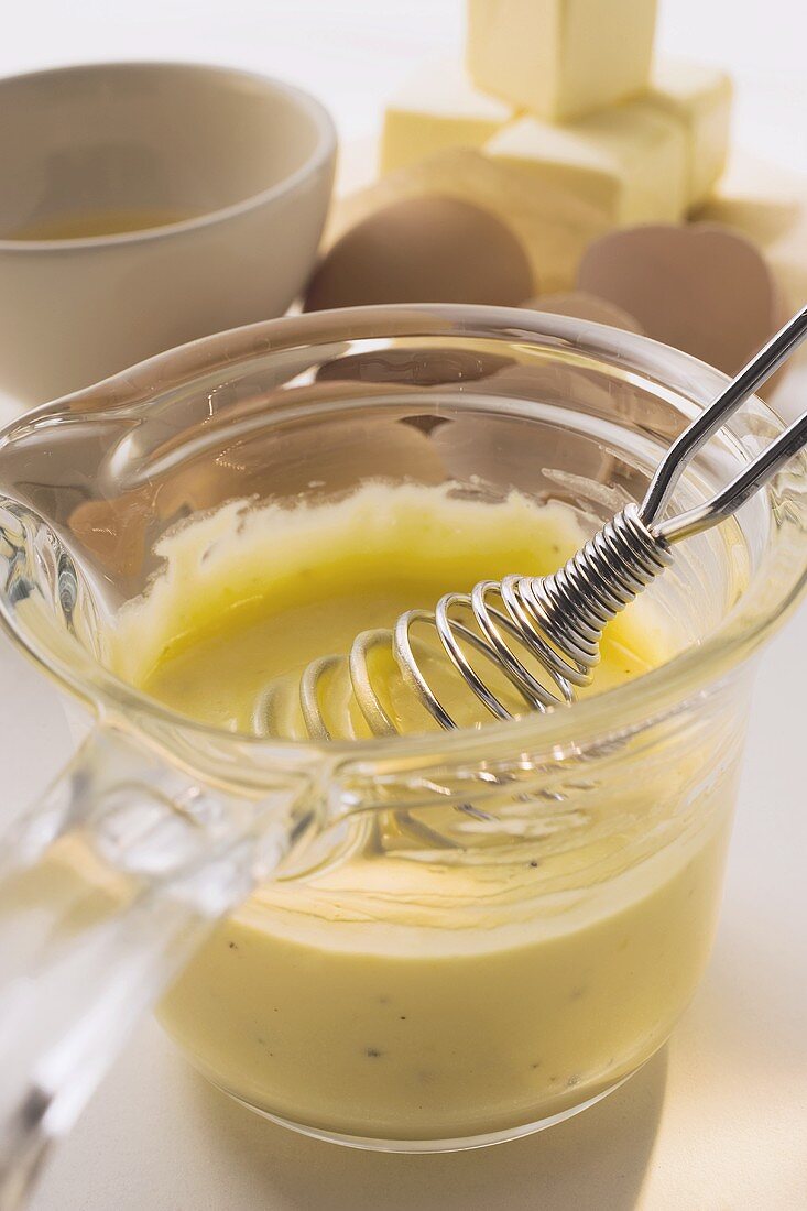 Hollandaise sauce in a small glass pan