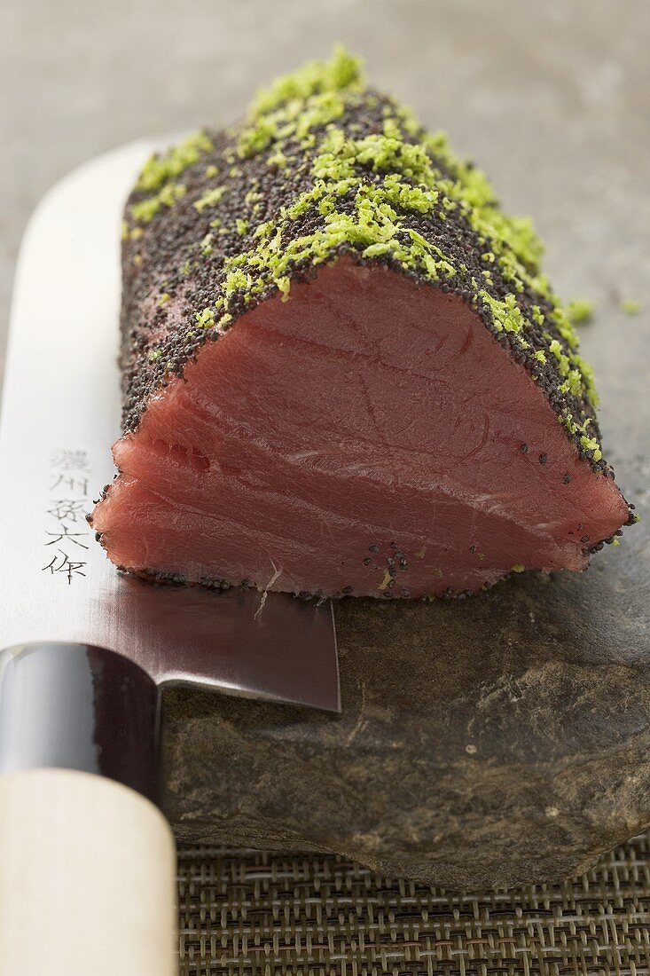 Rohes Thunfischfilet mit Mohn und Limettenzesten auf Messer