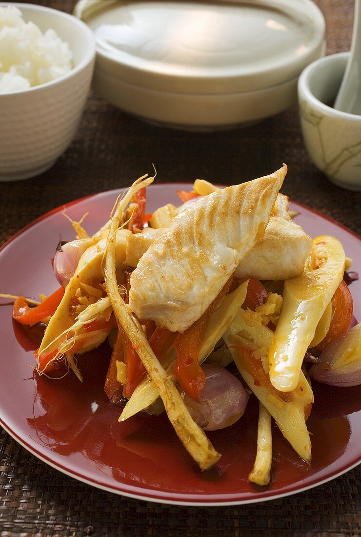 Fish fillets on bamboo shoots with peppers & enoki mushrooms