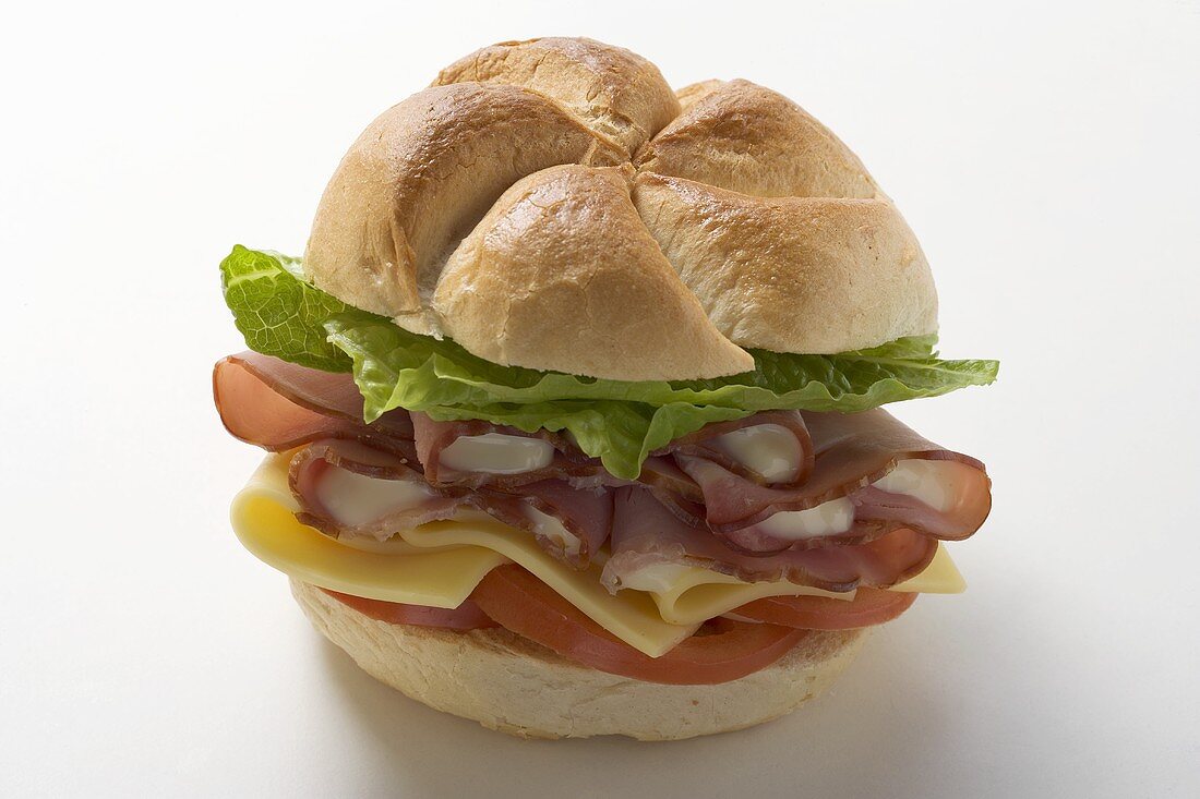 Ham, cheese, tomato and lettuce in a bread roll