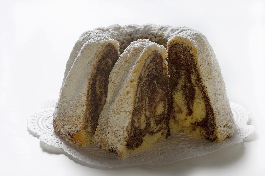 Marbled gugelhupf with icing sugar, a piece cut