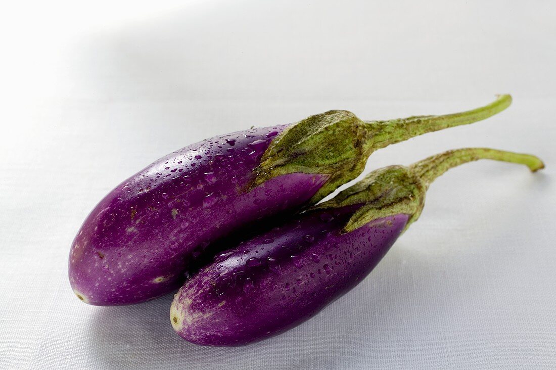 Two aubergines with drops of water