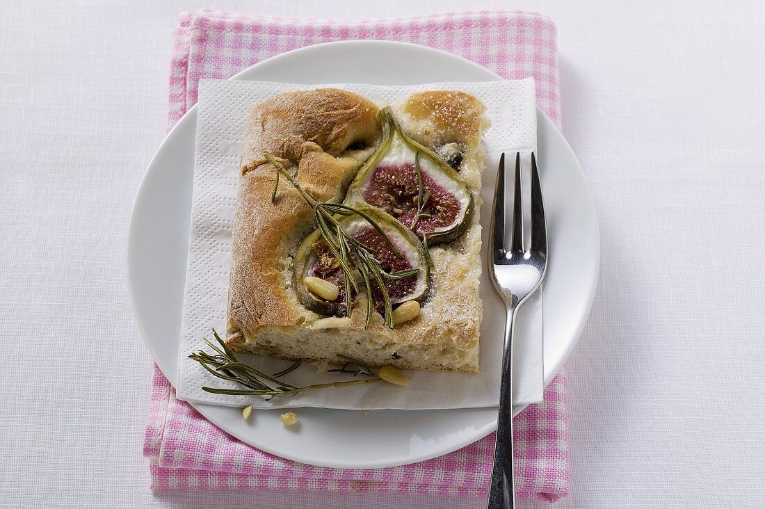 Piece of focaccia with figs, rosemary and pine nuts