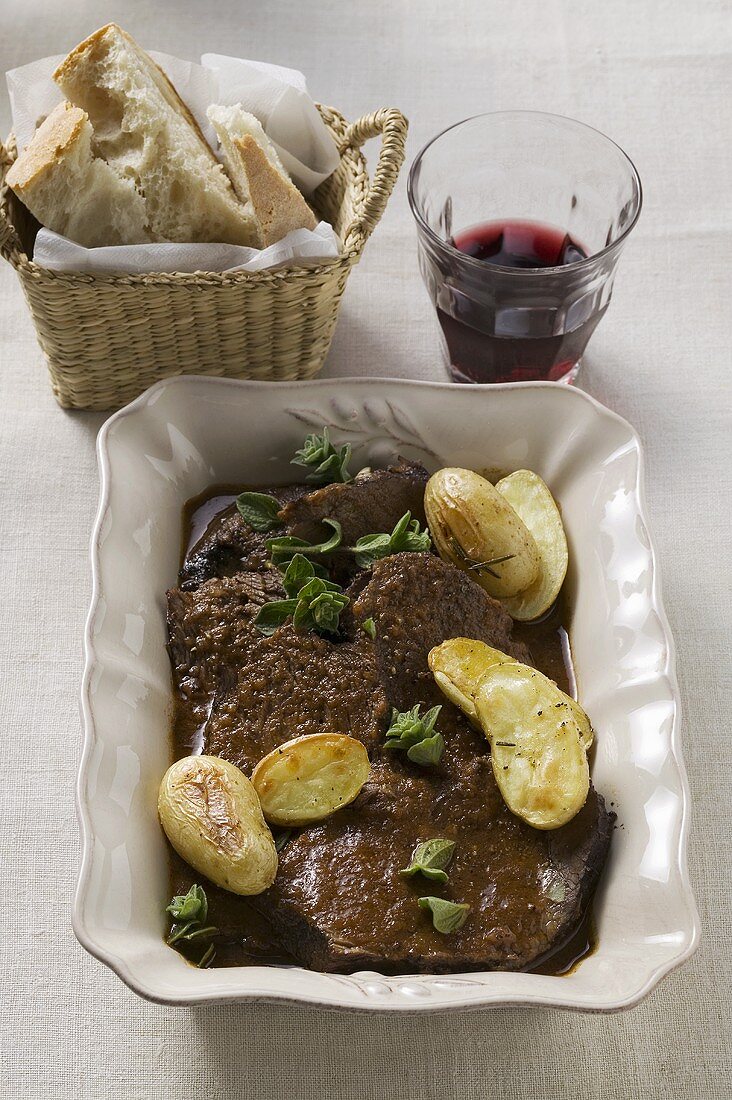 Beef pot roast with potatoes, red wine, white bread