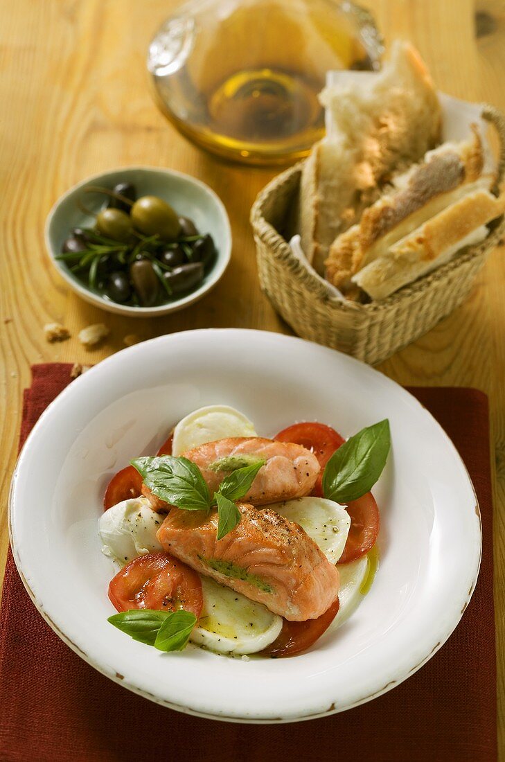 Tomatoes with mozzarella, salmon and basil