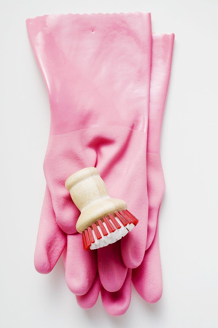 Pink rubber gloves and brush
