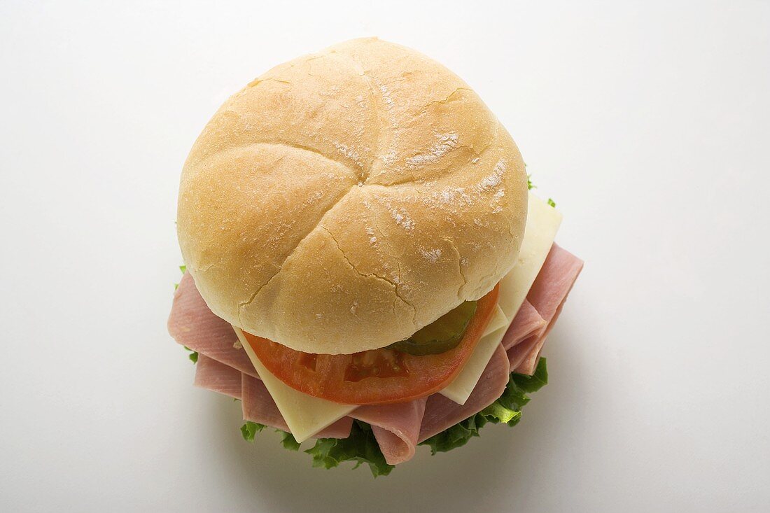 Ham, cheese, tomato and gherkin in kaiser roll