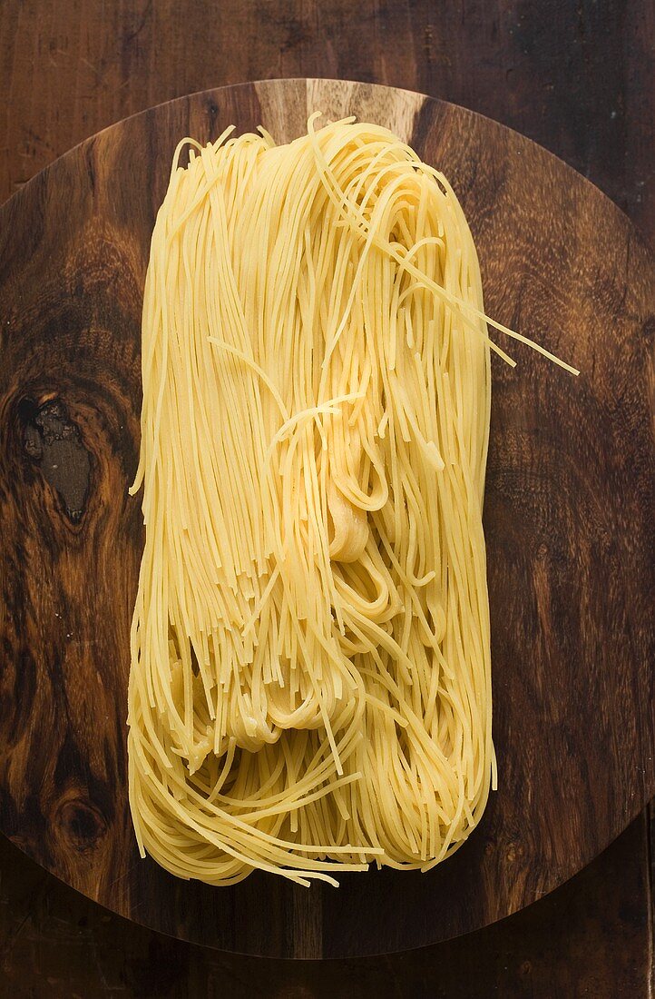 Egg noodles on wooden plate