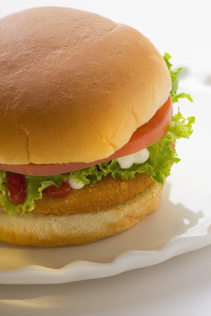 Chicken burger with tomato, lettuce, mayonnaise & ketchup