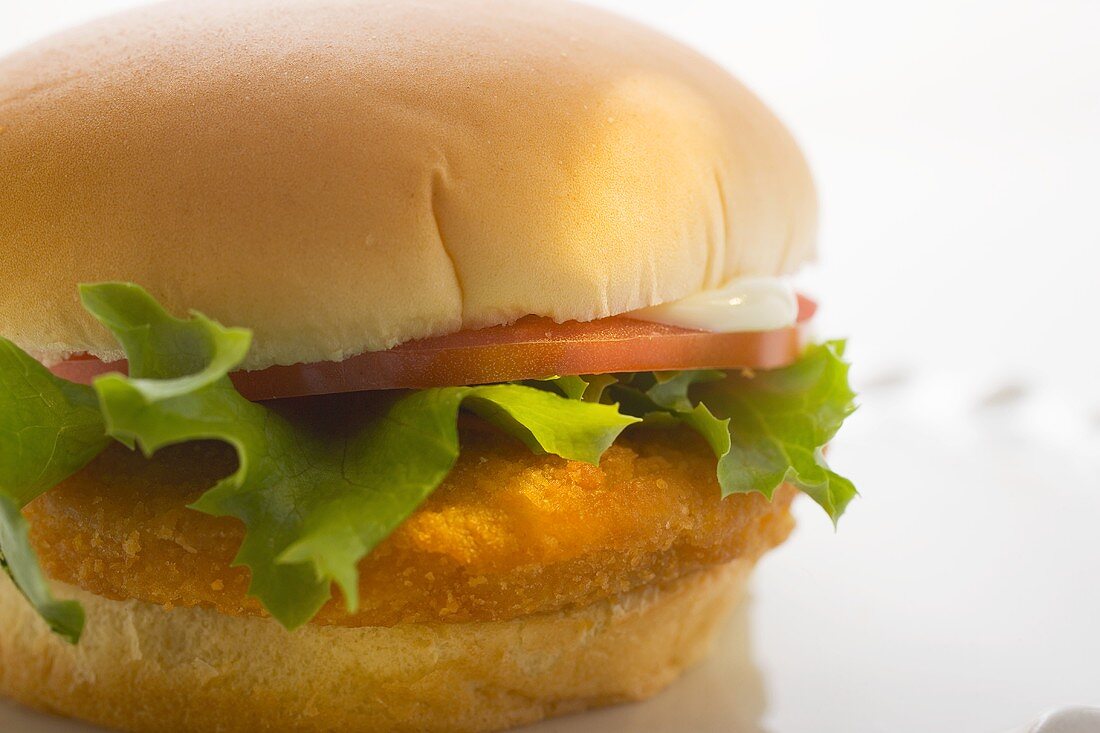 Chicken burger with tomato, mayonnaise and lettuce