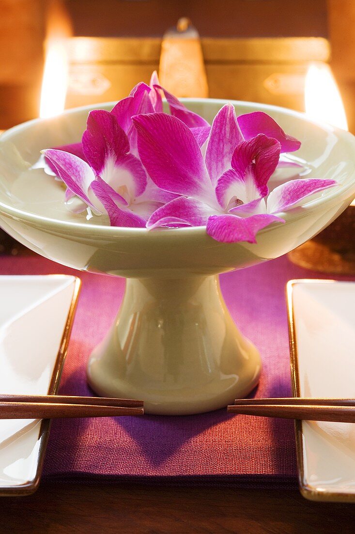Thai table decoration: orchids in bowl of water