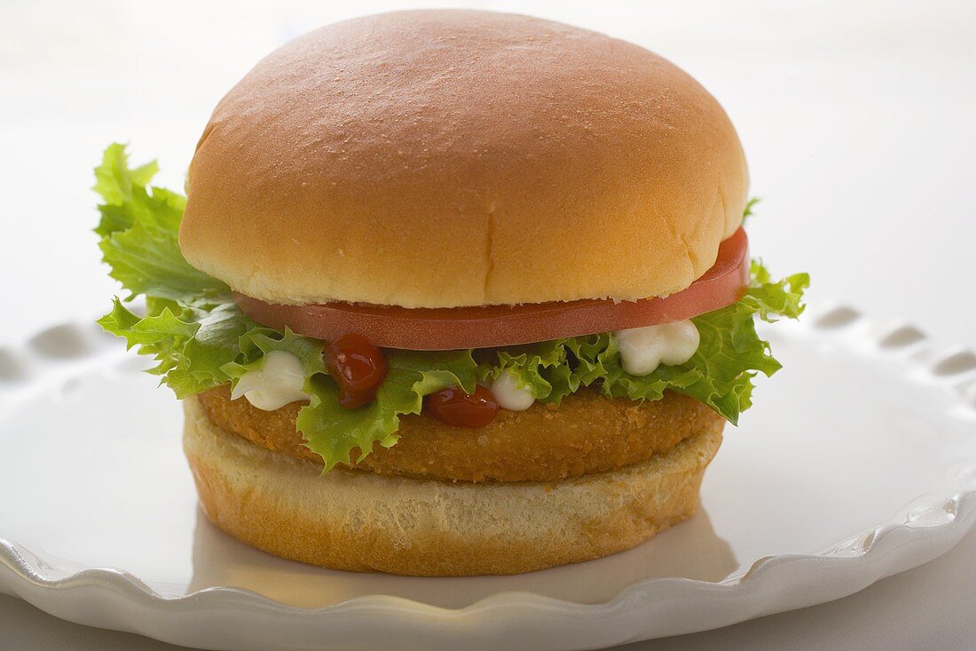 Chicken burger with tomato, lettuce, mayonnaise & ketchup