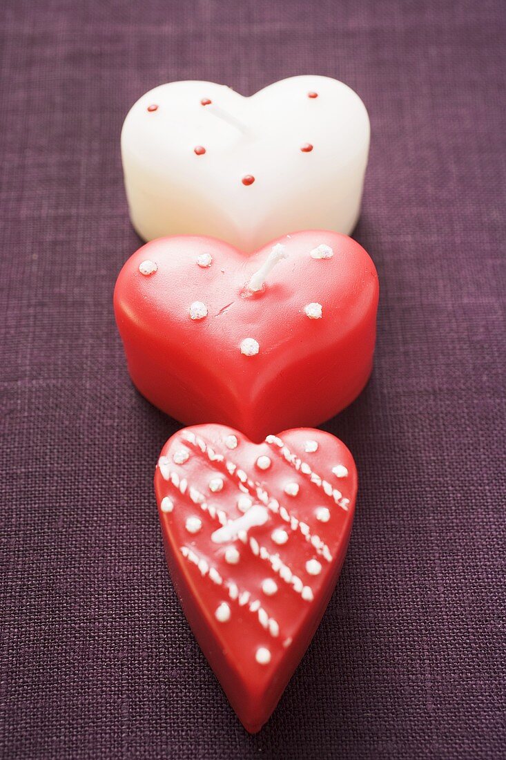 Three heart-shaped candles for Valentine's Day