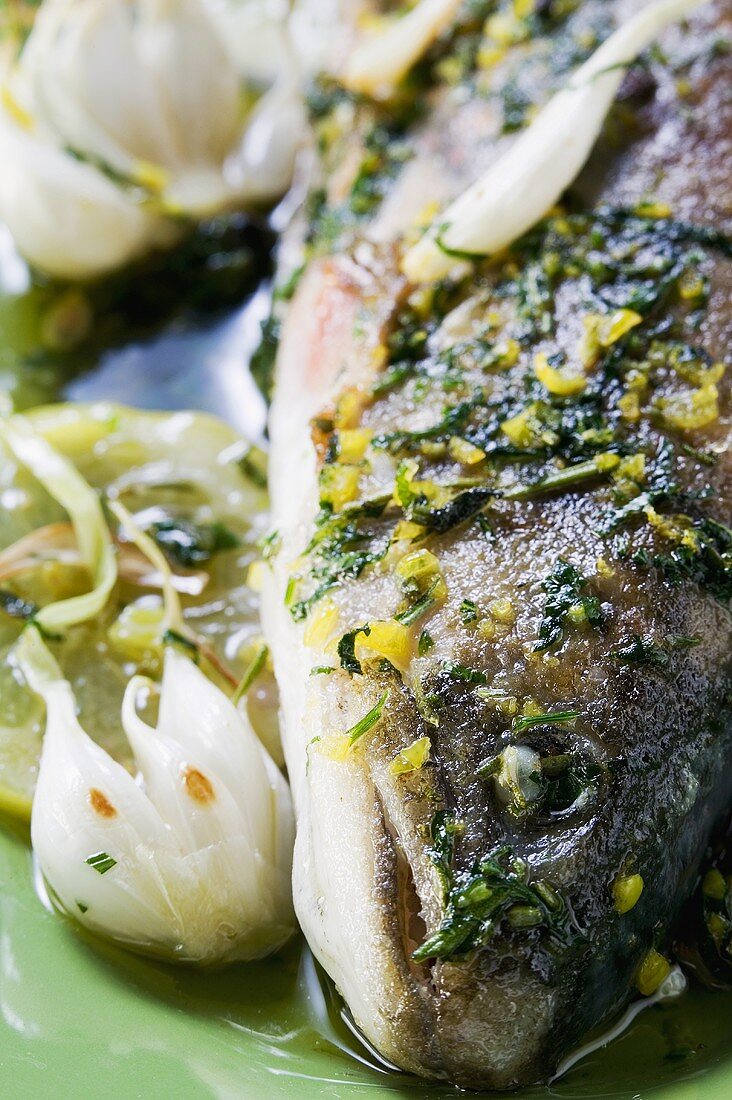 Fried fish with garlic, herbs and lemon