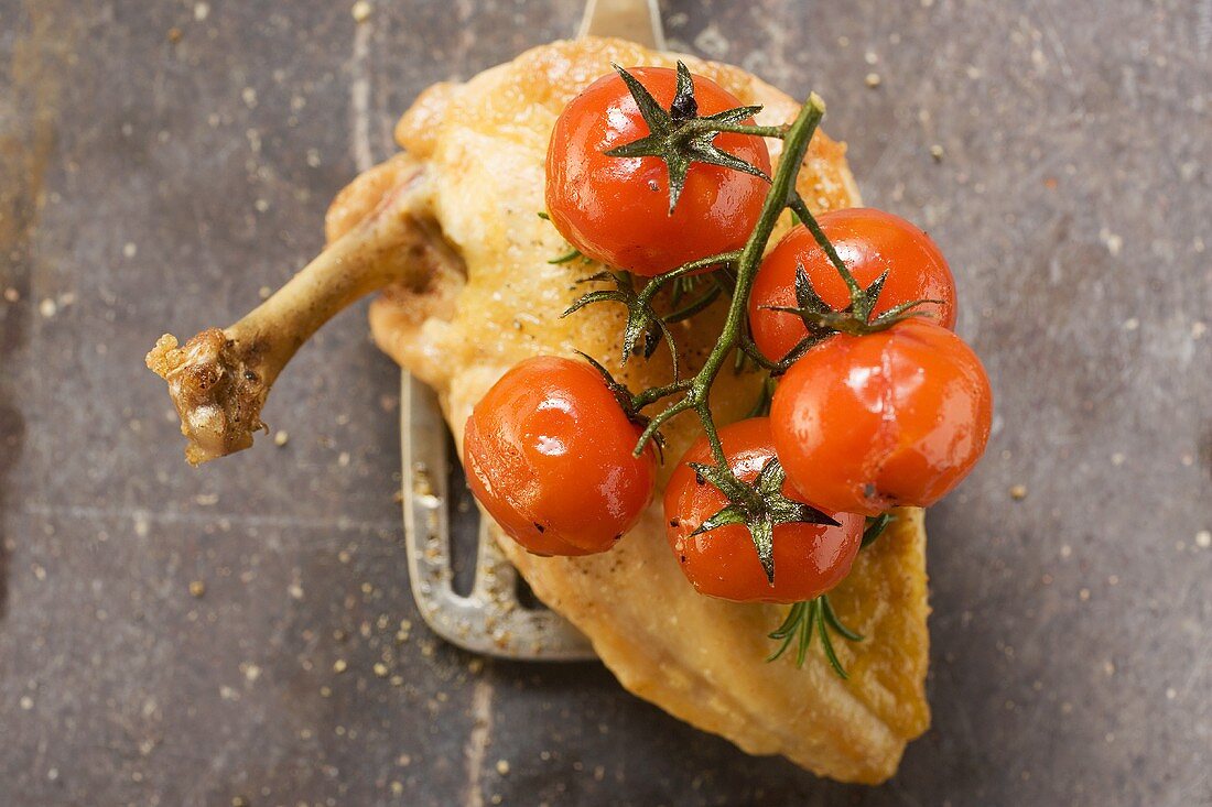 Fried chicken breast with cherry tomatoes on spatula