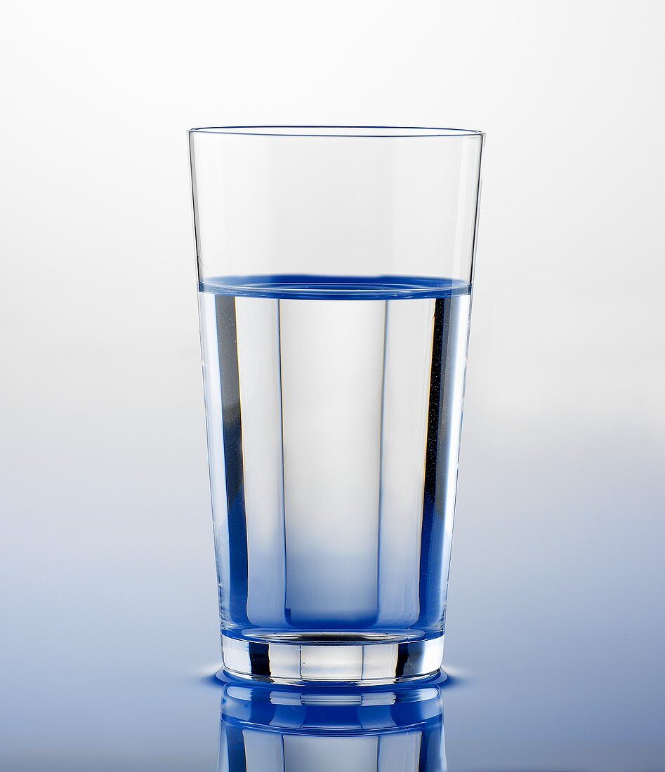Glass of water standing on water