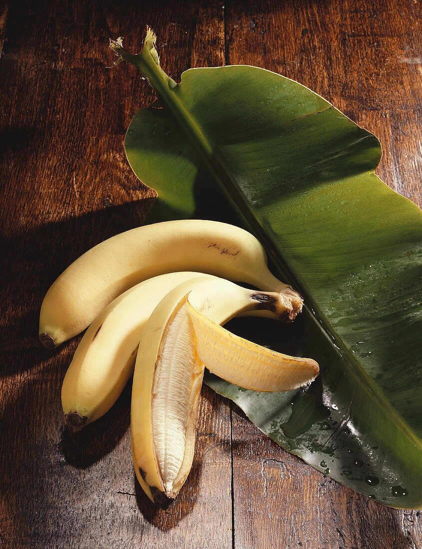 Three bananas on banana leaf