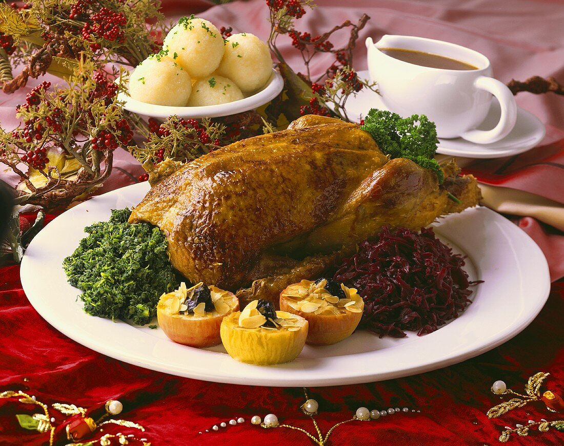 Christmas goose with kale, red cabbage, baked apples, dumplings