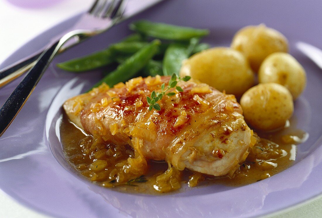 Chicken breast wrapped in ham with onion sauce, potatoes