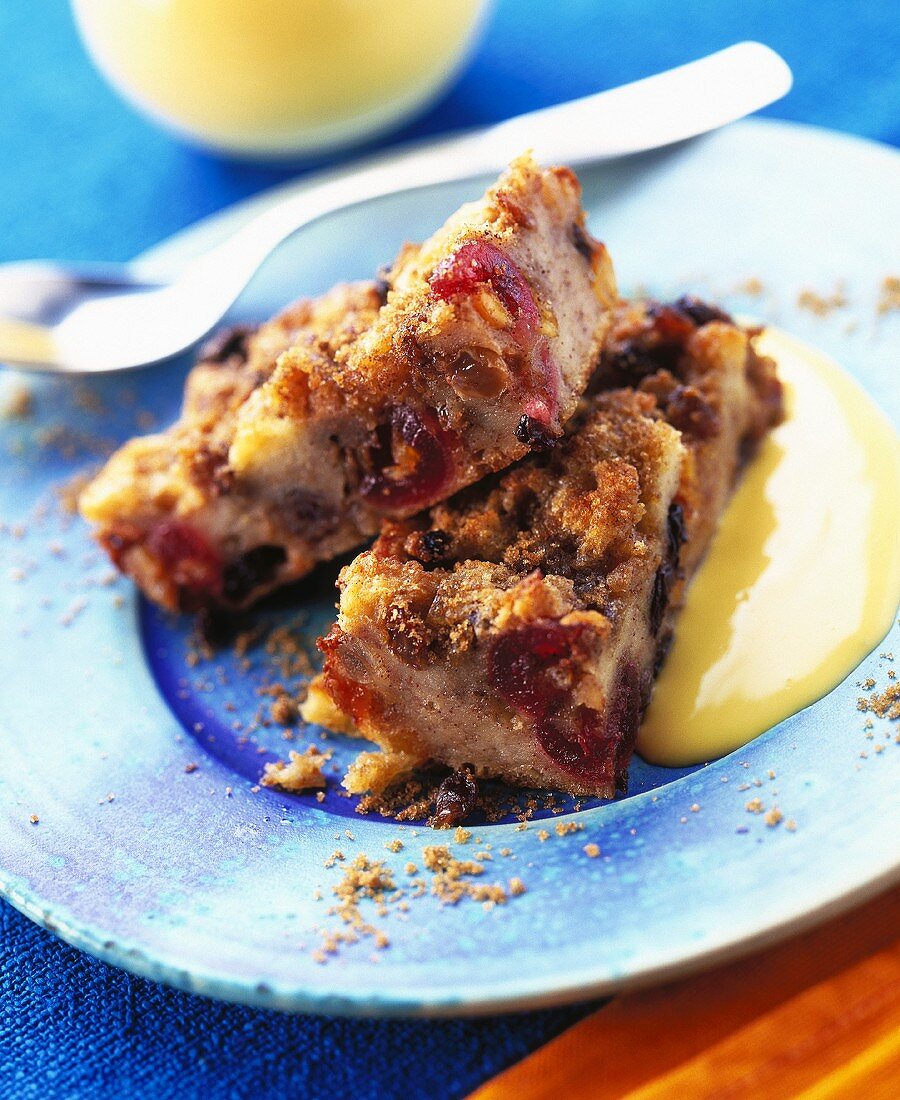 Two pieces of cinnamon cake with berries and custard
