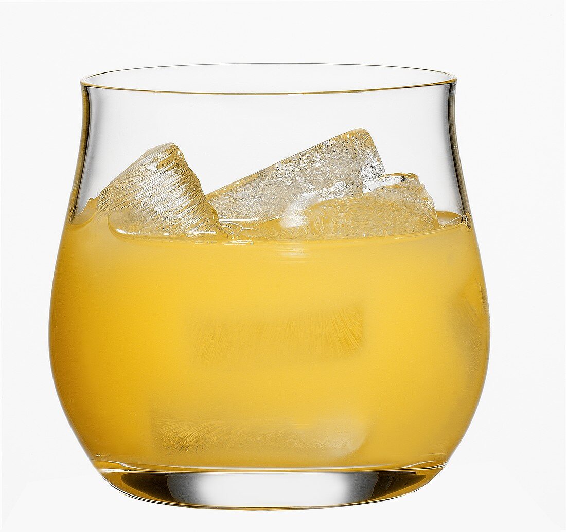 Orange juice with ice cubes in glass