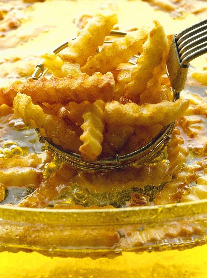 Chips being lifted out of hot fat