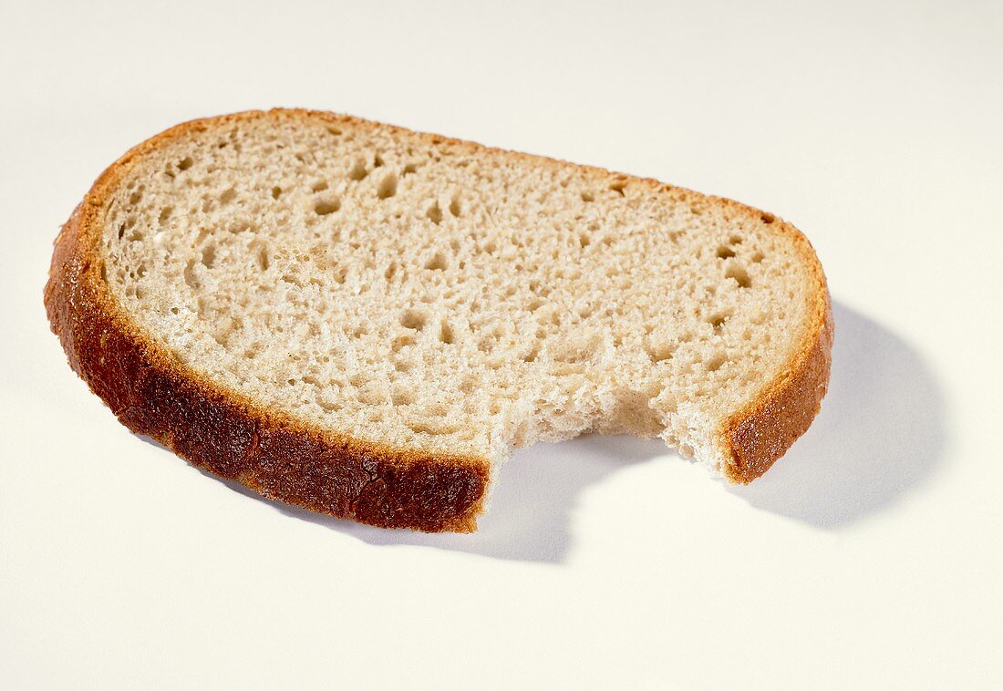 A slice of bread with a bite taken
