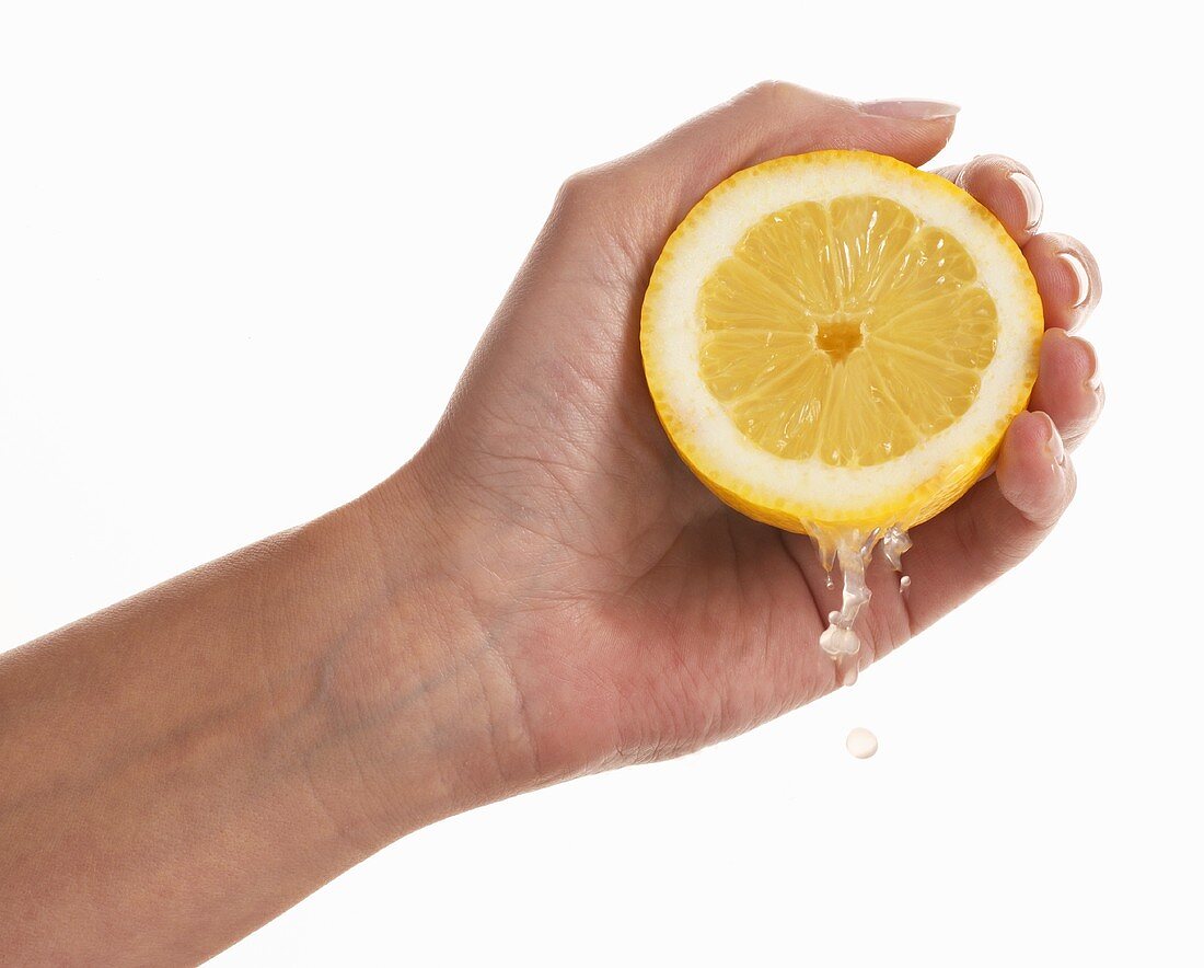 Woman's hand squeezing a lemon