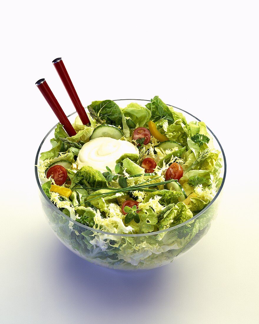 A bowl of green salad with tomatoes, peppers & mayonnaise