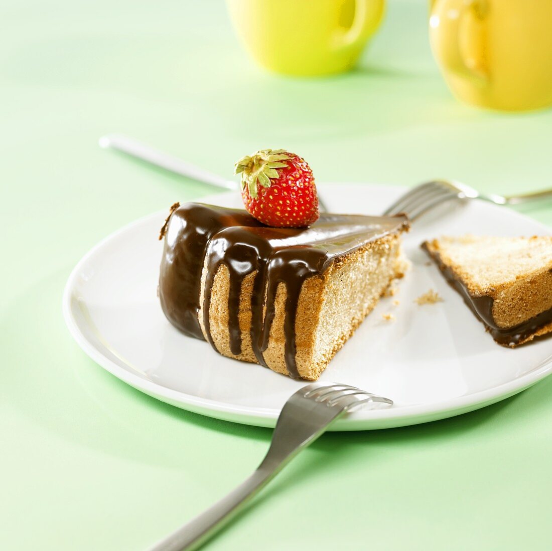 Sponge cake with chocolate icing and a strawberry