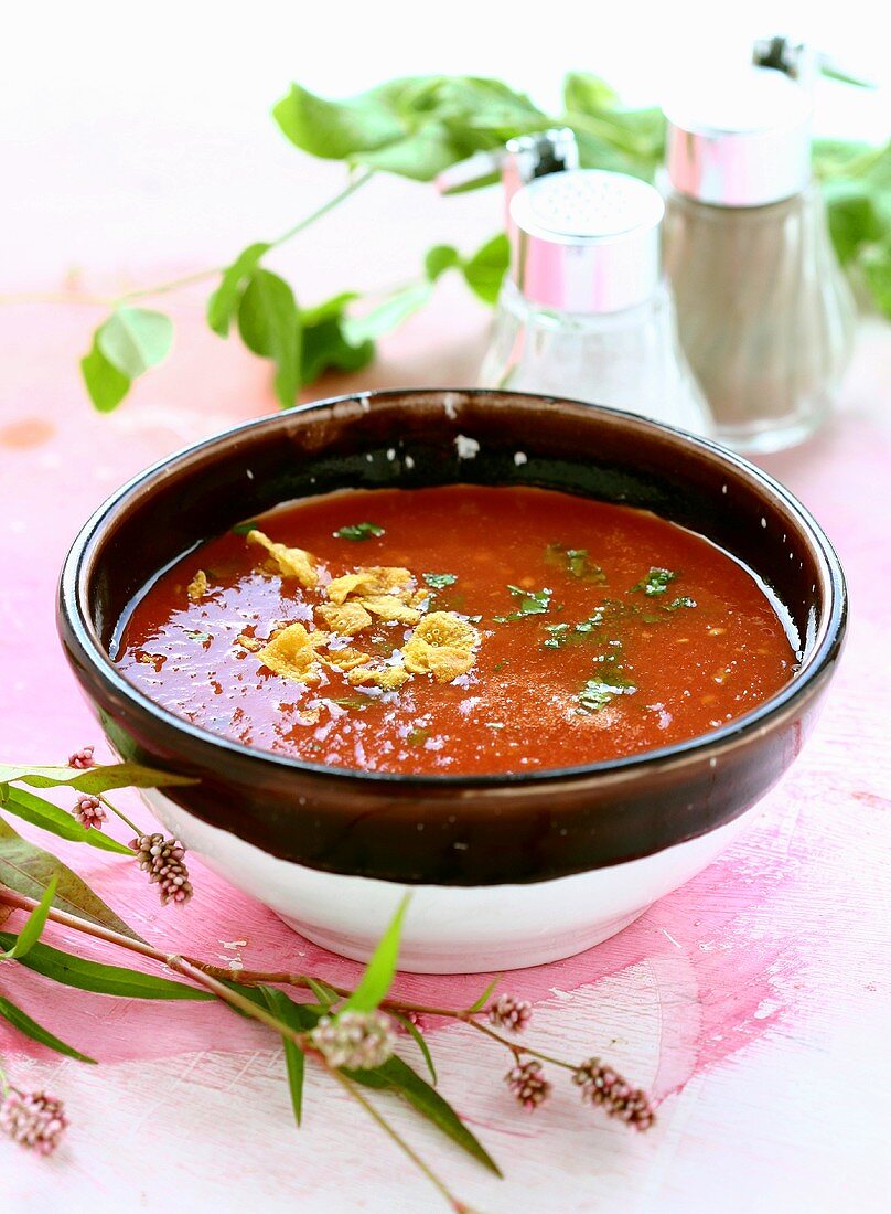 Tomato soup in a brown-rimmed bowl