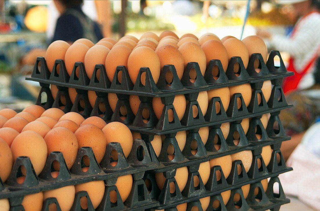 Several crates of eggs in a pile