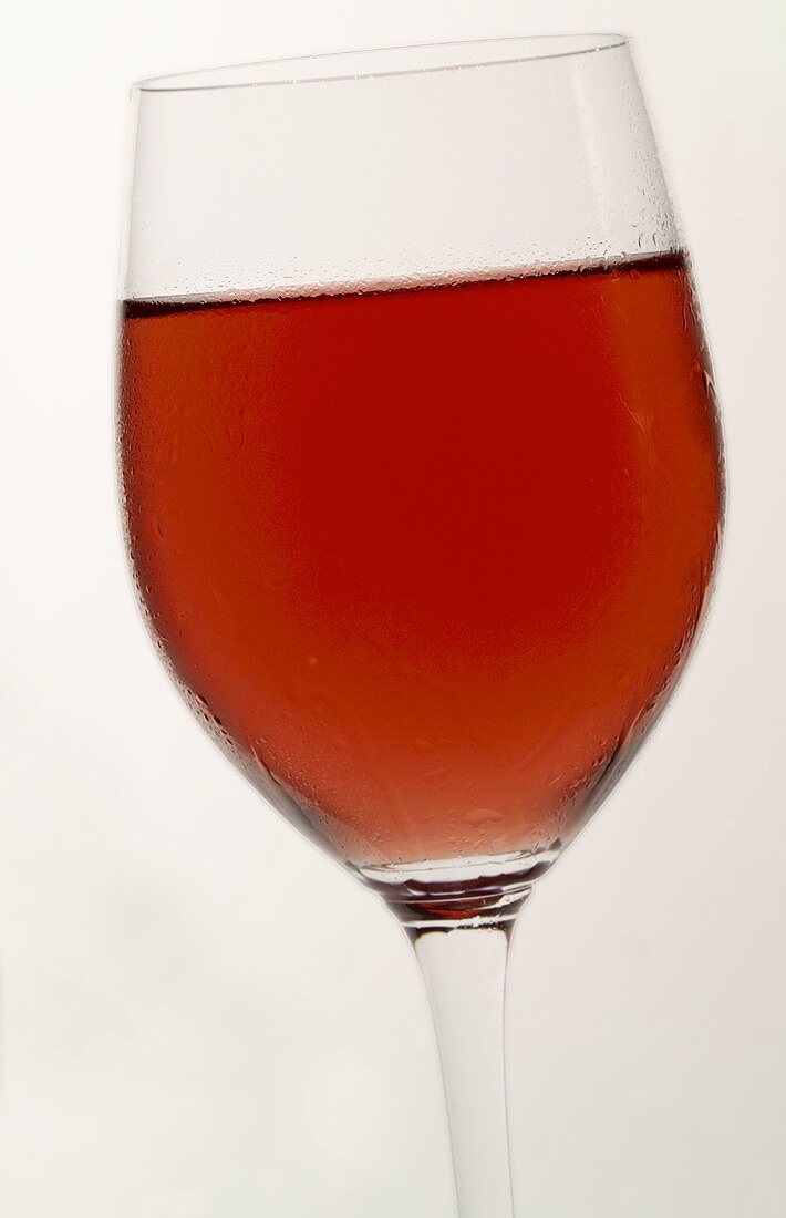 A glass of rosé wine with condensation