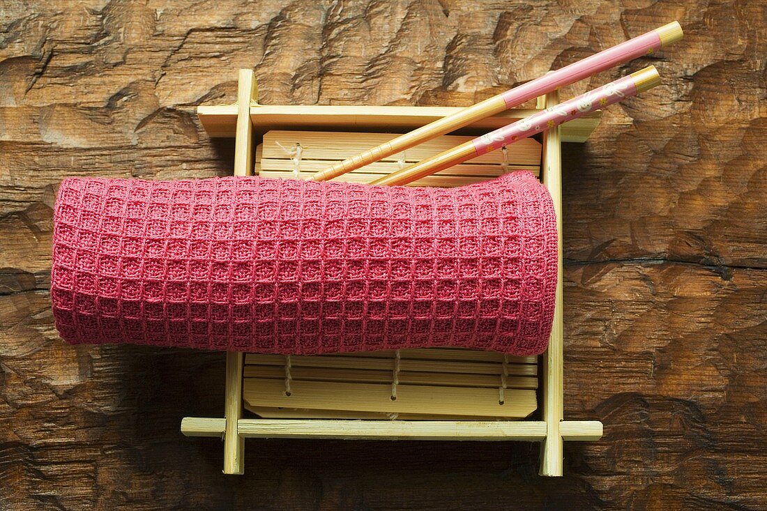 Asian table accessories: hand towel, chopsticks, bamboo mat